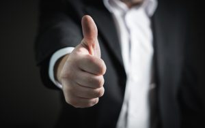 business name in white shirt and black jacket with thumb up